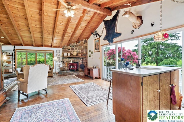 1132 Upperstump Rd, Hilltown Twp, PA 18914 - living room featuring wooden ceiling, light wood finished floors, a stone fireplace, and a ceiling fan