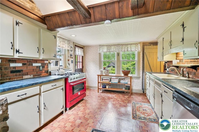 1132 Upperstump Rd, Hilltown Twp, PA 18914 - kitchen featuring stainless steel appliances, a sink, wallpapered walls, dark countertops, and brick patterned floors