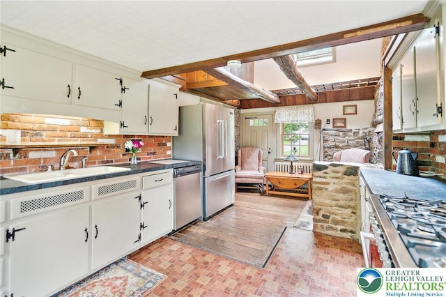 1132 Upperstump Rd, Hilltown Twp, PA 18914 - kitchen featuring appliances with stainless steel finishes, a sink, tasteful backsplash, and white cabinets