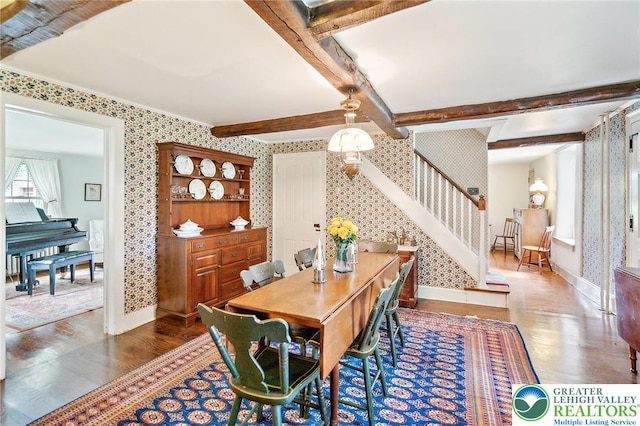 1132 Upperstump Rd, Hilltown Twp, PA 18914 - dining area with wallpapered walls, wood finished floors, baseboards, stairway, and beamed ceiling