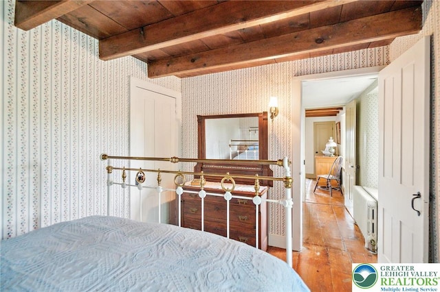 1132 Upperstump Rd, Hilltown Twp, PA 18914 - bedroom with wallpapered walls, radiator, wood finished floors, and wooden ceiling with exposed beams