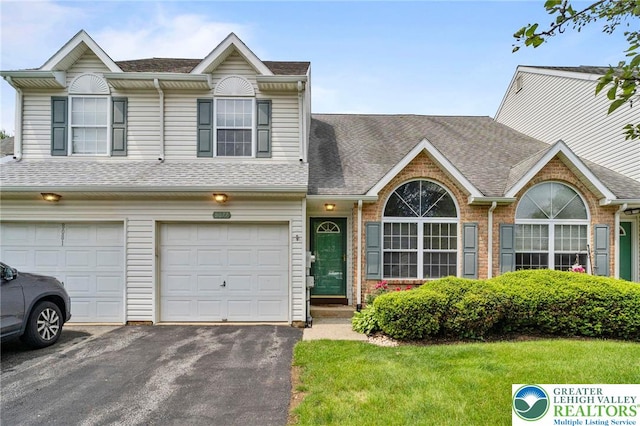 8077 Cross Creek Cir, Upper Macungie Twp, PA 18031 - view of property featuring driveway, a shingled roof, a front yard, brick siding, and an attached garage