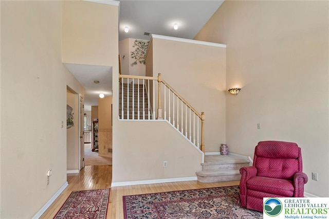 8077 Cross Creek Cir, Upper Macungie Twp, PA 18031 - living area with wood-type flooring, stairs, baseboards, and a towering ceiling