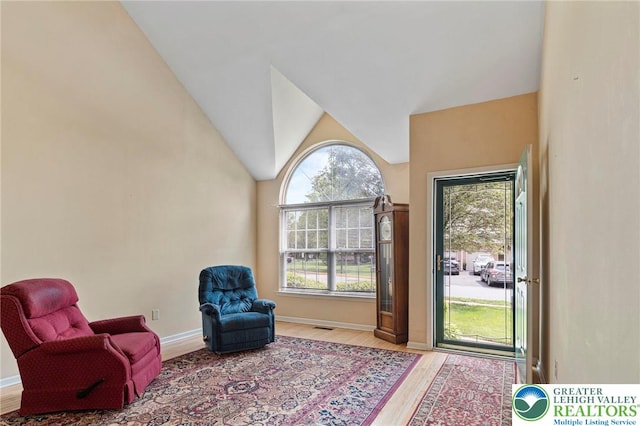 8077 Cross Creek Cir, Upper Macungie Twp, PA 18031 - living area with wood finished floors, vaulted ceiling, and baseboards