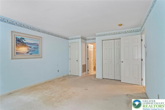 8077 Cross Creek Cir, Upper Macungie Twp, PA 18031 - unfurnished bedroom featuring light carpet, baseboards, and a closet