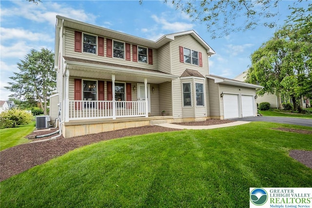 234 Venetian Dr, Forks Twp, PA 18040 - traditional-style home with covered porch, driveway, central AC unit, a front lawn, and a garage