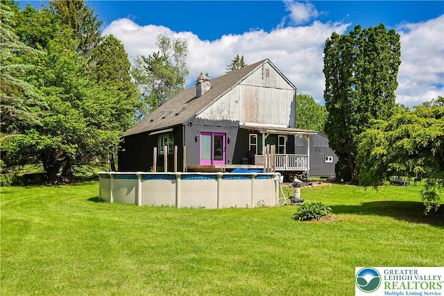 2671 Community, Moore Twp, PA 18014 - back of property with a lawn, a chimney, and an outdoor pool