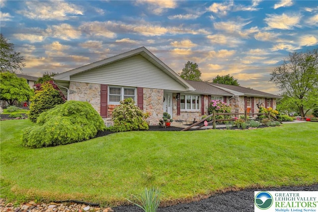 4379 Meadow Ln, South Whitehall Twp, PA 18104 - single story home featuring stone siding and a lawn
