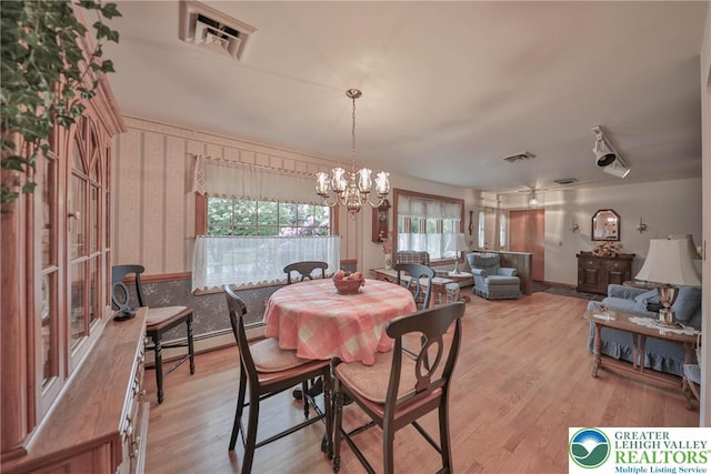 4379 Meadow Ln, South Whitehall Twp, PA 18104 - dining room featuring baseboard heating, wallpapered walls, light wood finished floors, a chandelier, and baseboards