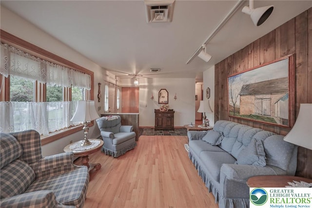 4379 Meadow Ln, South Whitehall Twp, PA 18104 - living area with wood finished floors, rail lighting, and wood walls