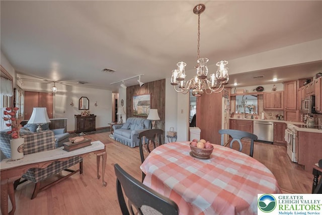 4379 Meadow Ln, South Whitehall Twp, PA 18104 - dining space with light wood-type flooring and a chandelier