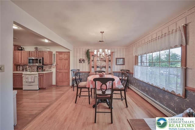 4379 Meadow Ln, South Whitehall Twp, PA 18104 - dining space featuring a chandelier, a baseboard radiator, and light wood-type flooring