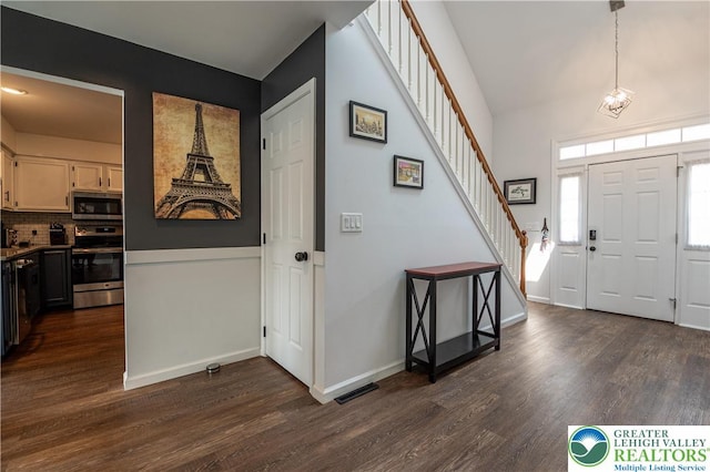 1411 Howard Ln, Palmer Twp, PA 18045 - entrance foyer featuring stairs, dark wood-style floors, and baseboards