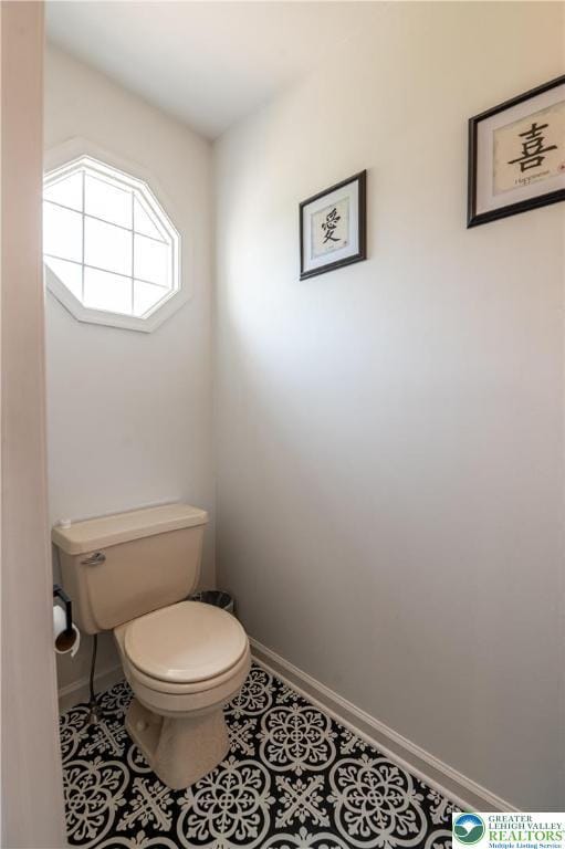 1411 Howard Ln, Palmer Twp, PA 18045 - bathroom featuring toilet, baseboards, and tile patterned floors