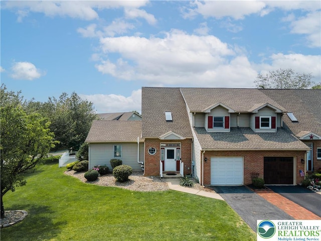 1411 Howard Ln, Palmer Twp, PA 18045 - view of front of home featuring driveway, a front lawn, brick siding, roof with shingles, and an attached garage
