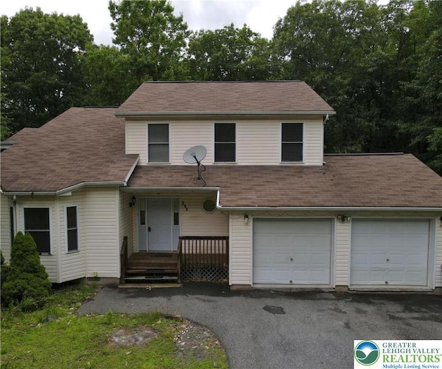 133 Summerton Cir, Stroud Twp, PA 18301 - view of front of house featuring a garage, asphalt driveway, a porch, and roof with shingles