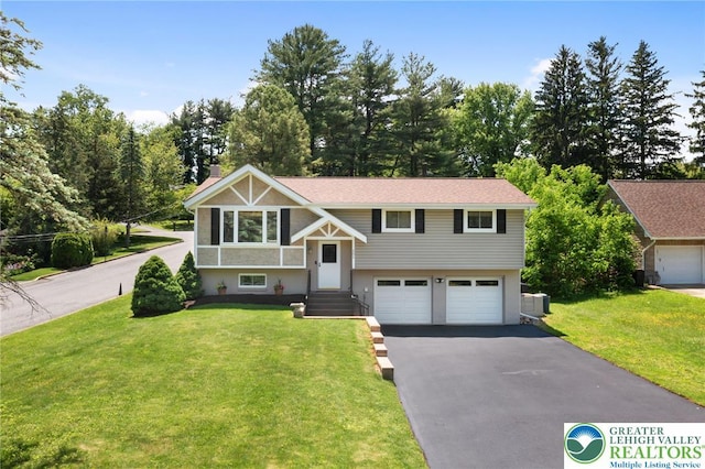 201 S 15th St, Emmaus Borough, PA 18049 - bi-level home featuring driveway, a garage, a front lawn, and a chimney
