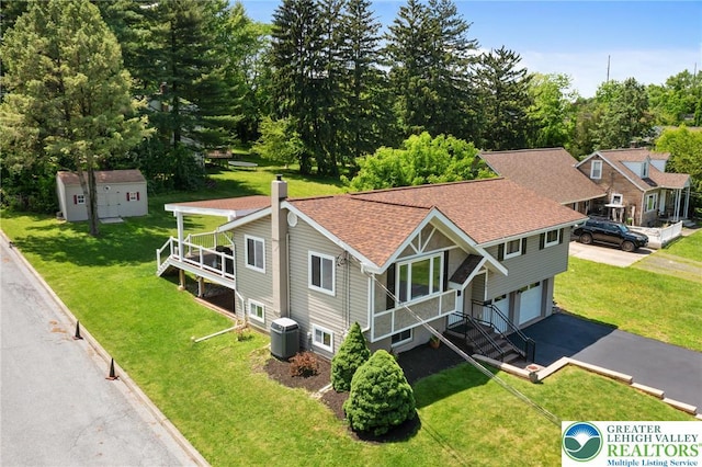 201 S 15th St, Emmaus Borough, PA 18049 - view of front of home featuring central air condition unit, driveway, an attached garage, roof with shingles, and a front lawn
