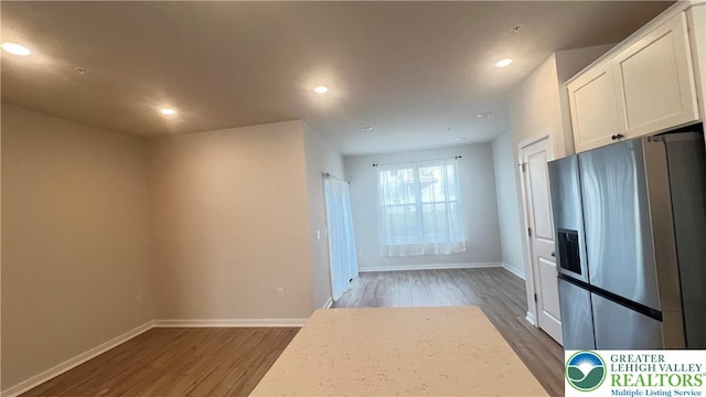 4904 Brookside Ct, Upper Saucon Twp, PA 18036 - interior space with stainless steel refrigerator with ice dispenser, wood finished floors, white cabinetry, baseboards, and recessed lighting