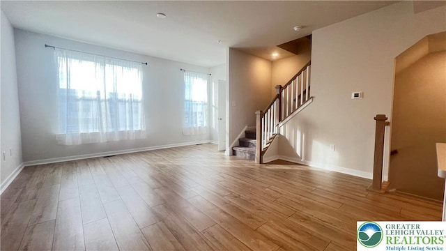 4904 Brookside Ct, Upper Saucon Twp, PA 18036 - unfurnished living room with wood finished floors, stairs, and baseboards