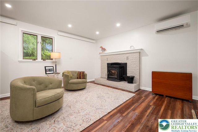 1580 Old Bethlehem Rd, Springfield Twp, PA 18951 - living room with a wall unit AC, wood finished floors, a wood stove, recessed lighting, and baseboards