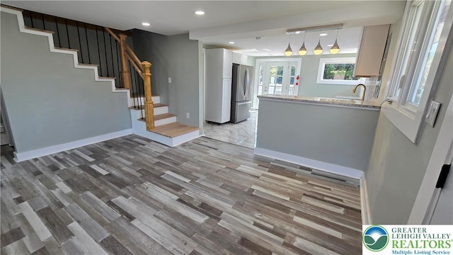 1126 Charles St, Luzerne, PA 18702 - kitchen featuring freestanding refrigerator, light wood finished floors, recessed lighting, a peninsula, and a sink