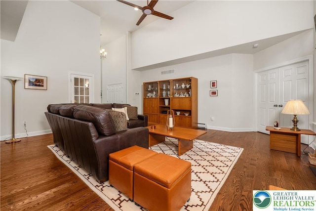 222 Danbury Dr, Bushkill Twp, PA 18064 - living area featuring high vaulted ceiling, ceiling fan, baseboards, wood finished floors, and a baseboard heating unit