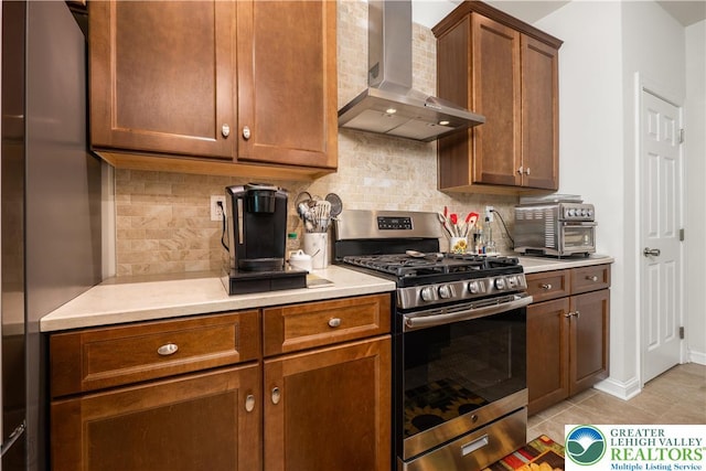 222 Danbury Dr, Bushkill Twp, PA 18064 - kitchen featuring appliances with stainless steel finishes, wall chimney exhaust hood, light countertops, and decorative backsplash