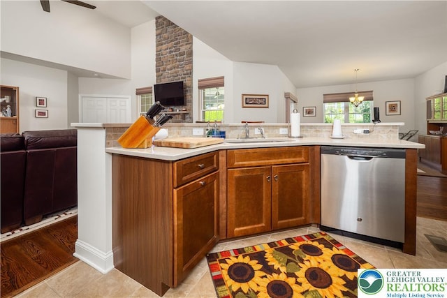 222 Danbury Dr, Bushkill Twp, PA 18064 - kitchen featuring dishwasher, open floor plan, a sink, lofted ceiling, and light countertops