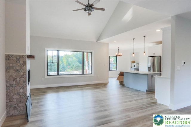 448 Long Lane Rd, Lehigh Twp, PA 18088 - unfurnished living room with healthy amount of natural light, ceiling fan, light wood-type flooring, a fireplace, and lofted ceiling