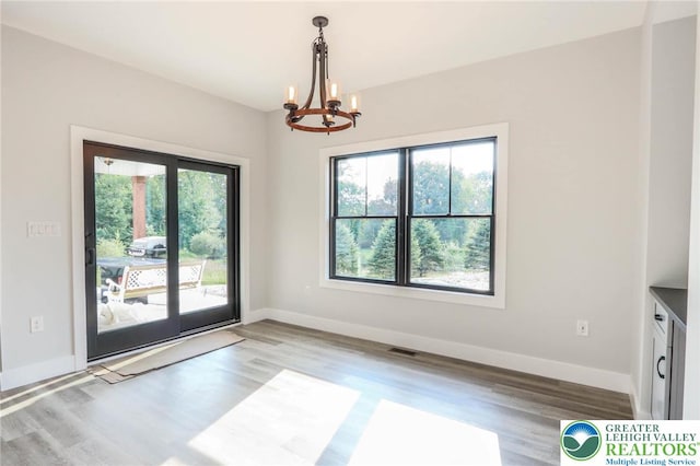 448 Long Lane Rd, Lehigh Twp, PA 18088 - unfurnished dining area featuring a chandelier, wood finished floors, and baseboards