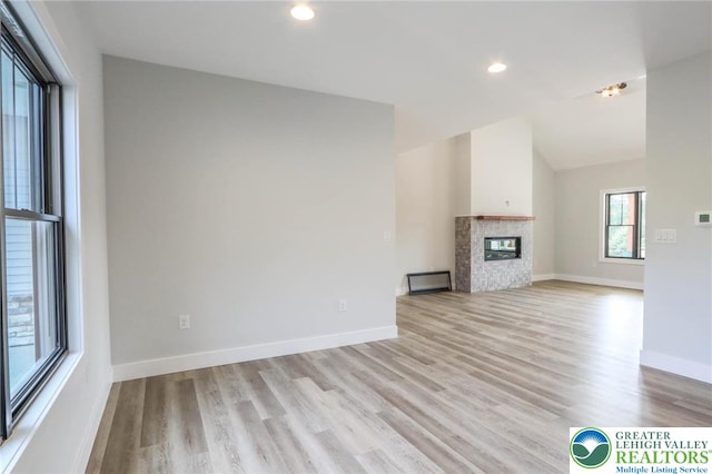 448 Long Lane Rd, Lehigh Twp, PA 18088 - unfurnished living room with light wood-type flooring, recessed lighting, baseboards, a glass covered fireplace, and lofted ceiling