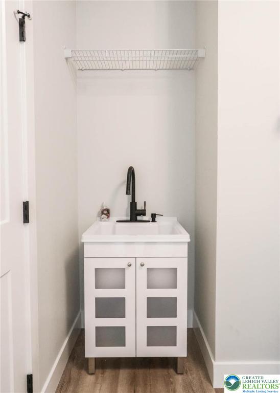448 Long Lane Rd, Lehigh Twp, PA 18088 - washroom featuring a sink, wood finished floors, and baseboards