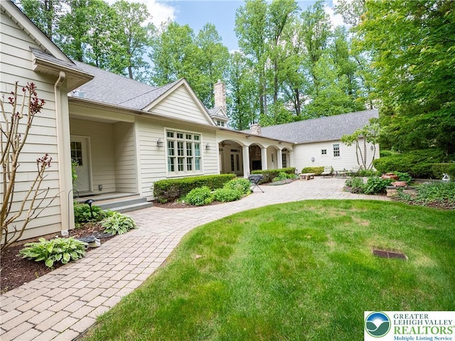 5355 Saucon Ridge Rd, Upper Saucon Twp, PA 18036 - rear view of house featuring a chimney and a lawn