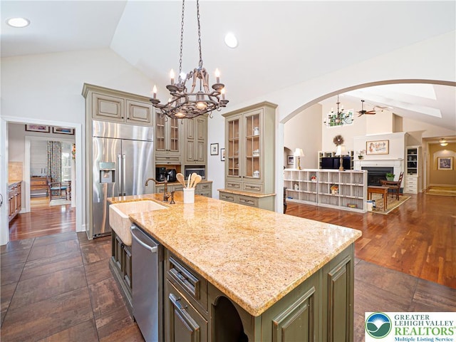 5355 Saucon Ridge Rd, Upper Saucon Twp, PA 18036 - kitchen featuring a chandelier, appliances with stainless steel finishes, arched walkways, cream cabinets, and high vaulted ceiling