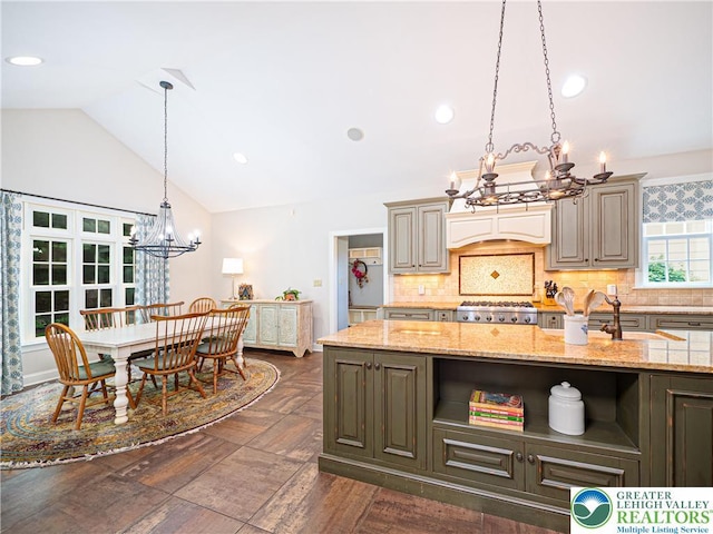 5355 Saucon Ridge Rd, Upper Saucon Twp, PA 18036 - kitchen featuring a chandelier, lofted ceiling, decorative backsplash, decorative light fixtures, and light stone counters