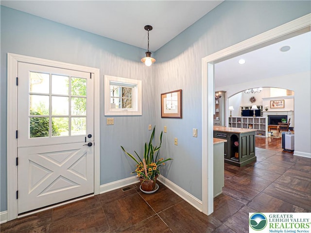 5355 Saucon Ridge Rd, Upper Saucon Twp, PA 18036 - entryway featuring baseboards, a fireplace, and arched walkways