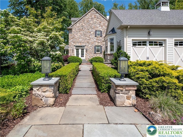 5355 Saucon Ridge Rd, Upper Saucon Twp, PA 18036 - view of front of home featuring stone siding, a garage, and roof with shingles