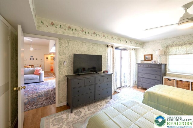 2765 Rolling Green Pl, Lower Macungie Twp, PA 18062 - bedroom with light wood-style flooring, multiple windows, wallpapered walls, and baseboards