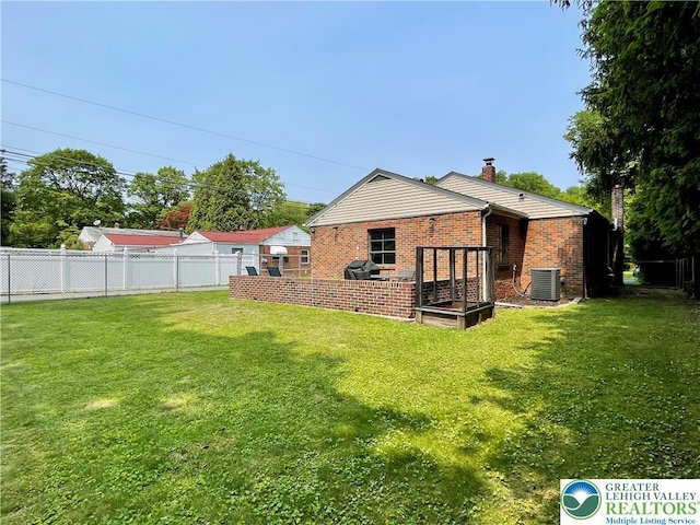 938 N Broad St, Allentown City, PA 18104 - rear view of house featuring central air condition unit, brick siding, and a chimney