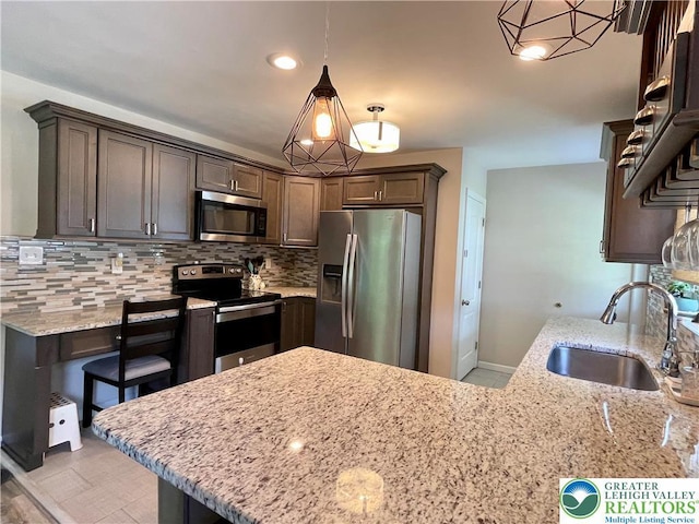 938 N Broad St, Allentown City, PA 18104 - kitchen with stainless steel appliances, a sink, light stone countertops, tasteful backsplash, and recessed lighting