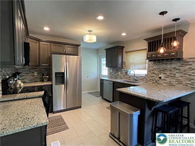 938 N Broad St, Allentown City, PA 18104 - kitchen featuring appliances with stainless steel finishes, a sink, a peninsula, tasteful backsplash, and light stone countertops