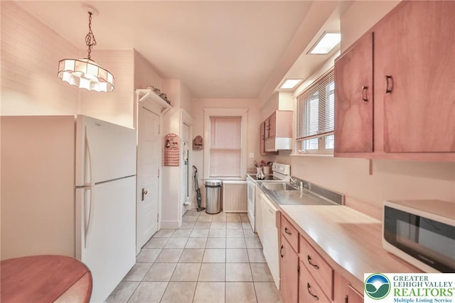 30 S 16th St, Wilson Boro, PA 18042 - kitchen featuring white appliances, light countertops, light tile patterned flooring, and hanging light fixtures