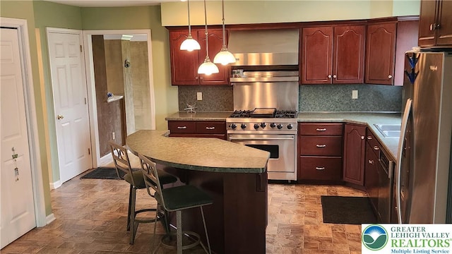 391 W Mayfield Cir, Lower Nazareth Twp, PA 18020 - kitchen with appliances with stainless steel finishes, a kitchen breakfast bar, backsplash, hanging light fixtures, and a kitchen island