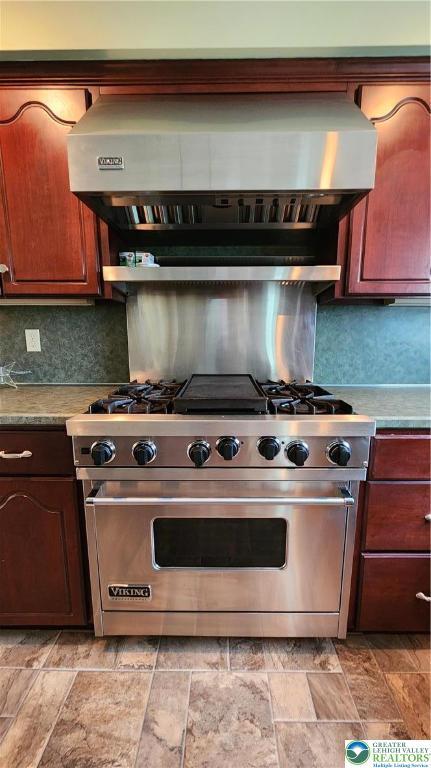 391 W Mayfield Cir, Lower Nazareth Twp, PA 18020 - kitchen featuring premium range, tasteful backsplash, light stone finish flooring, and exhaust hood