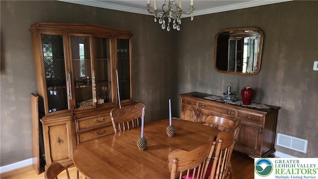 391 W Mayfield Cir, Lower Nazareth Twp, PA 18020 - dining area featuring a chandelier, crown molding, baseboards, and wood finished floors