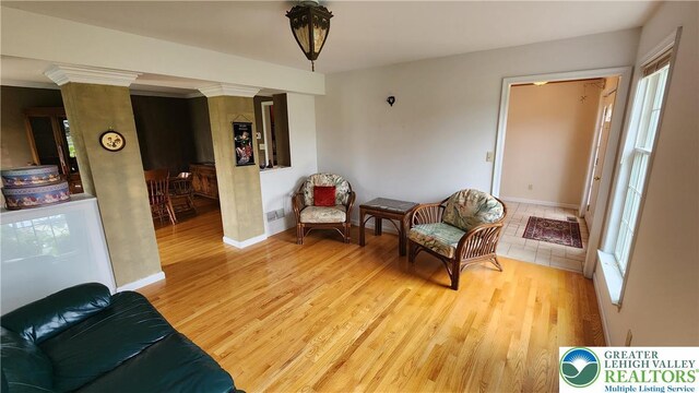 391 W Mayfield Cir, Lower Nazareth Twp, PA 18020 - sitting room featuring wood finished floors, baseboards, plenty of natural light, and ornate columns