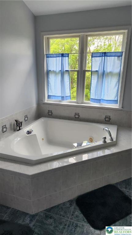 391 W Mayfield Cir, Lower Nazareth Twp, PA 18020 - bathroom featuring a jetted tub and tile patterned flooring