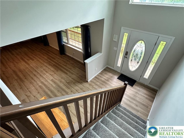 7190 Rimrock Dr, Coolbaugh Twp, PA 18466 - foyer with wood finished floors, a high ceiling, stairs, and baseboards