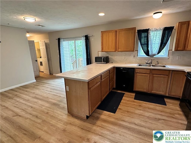 7190 Rimrock Dr, Coolbaugh Twp, PA 18466 - kitchen featuring black dishwasher, a sink, a peninsula, light countertops, and a textured ceiling